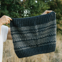 A handknitted Afterparty cowl shown in nature